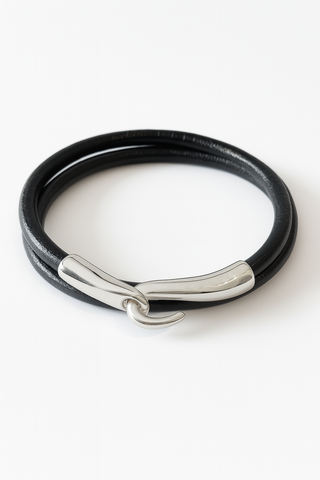 Silver tusk and leather bracelet.